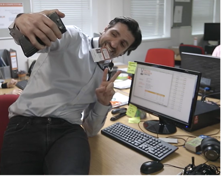 Male Taking a Selfie Infront of a Computer