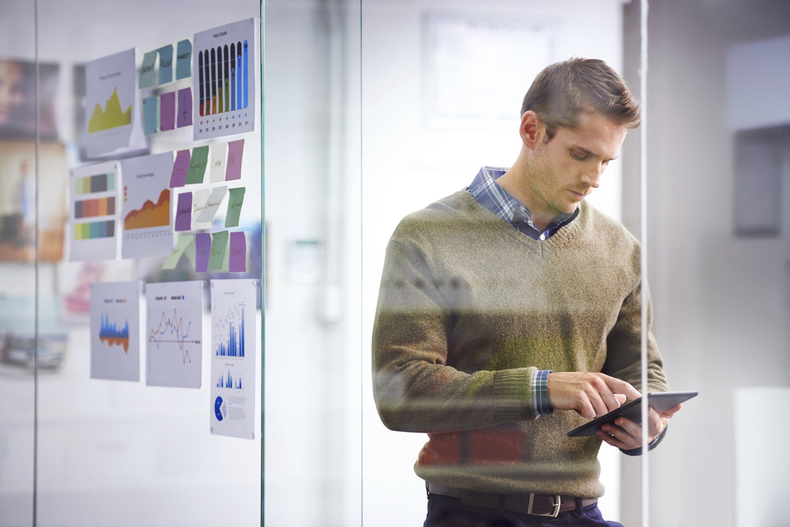 Man Using iPad to Analyse SaaS Email and App Security