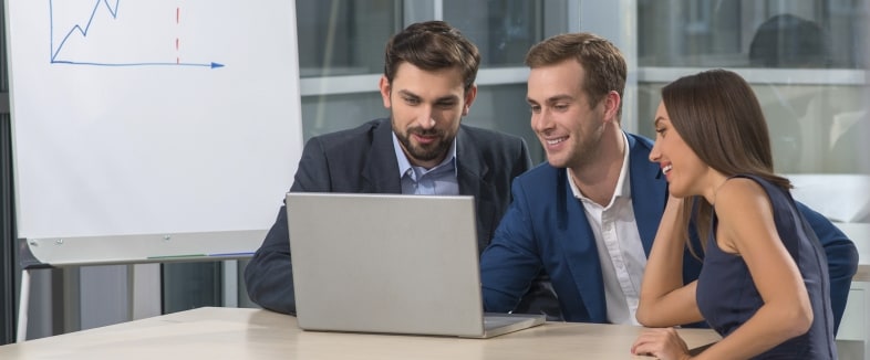 Three People Looking at Social Media Archive Platform on Laptop