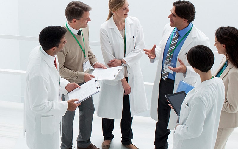 Medical professionals discussing healthcare email fraud attempts
