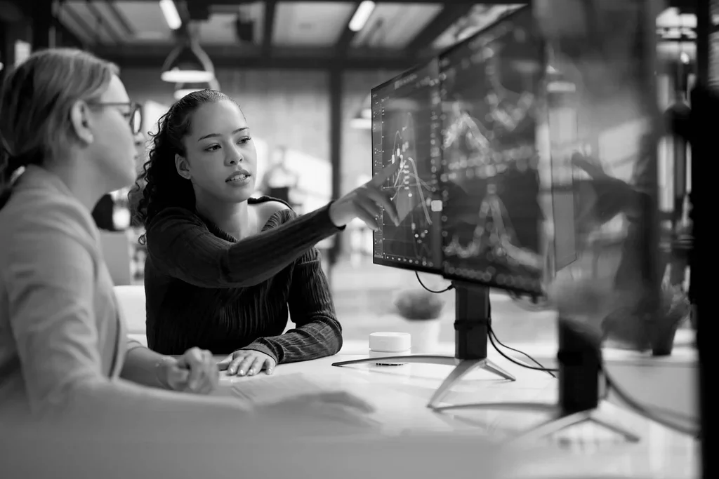 Cybersecurity professionals reviewing threat data on a computer monitor