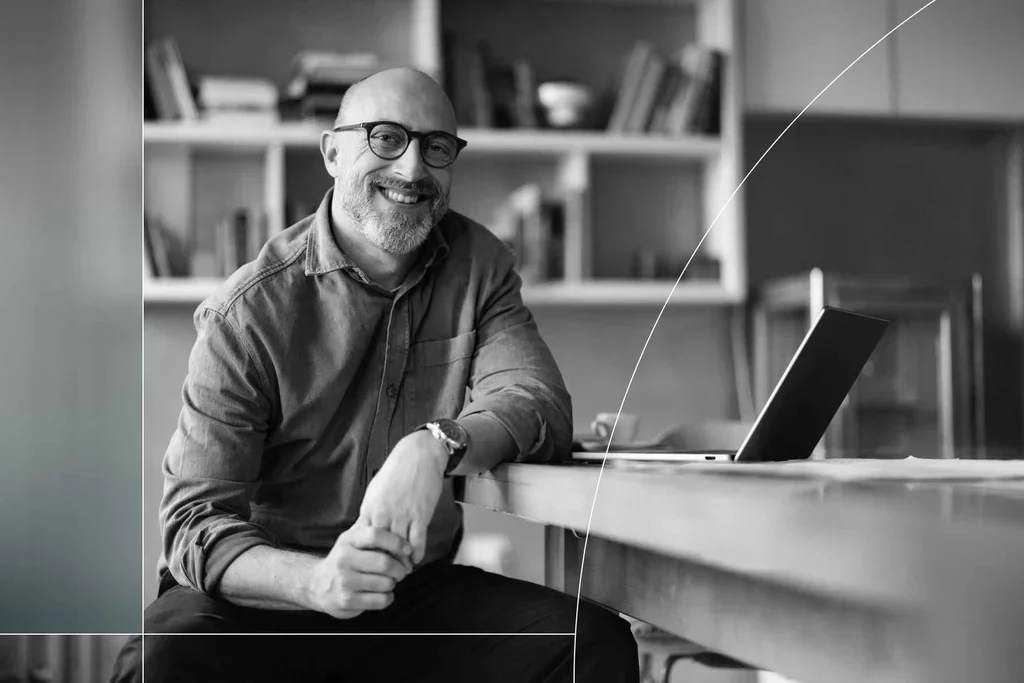 Cybersecurity professional seated beside a laptop in an office