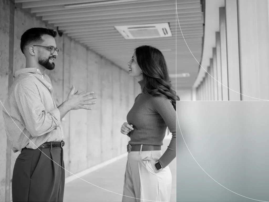Two colleagues discussing workplace security and human risk management.