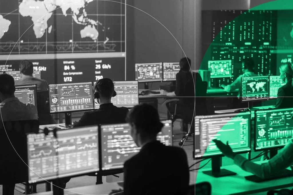 Cybersecurity operations team monitors network activity and threat data across multiple screens