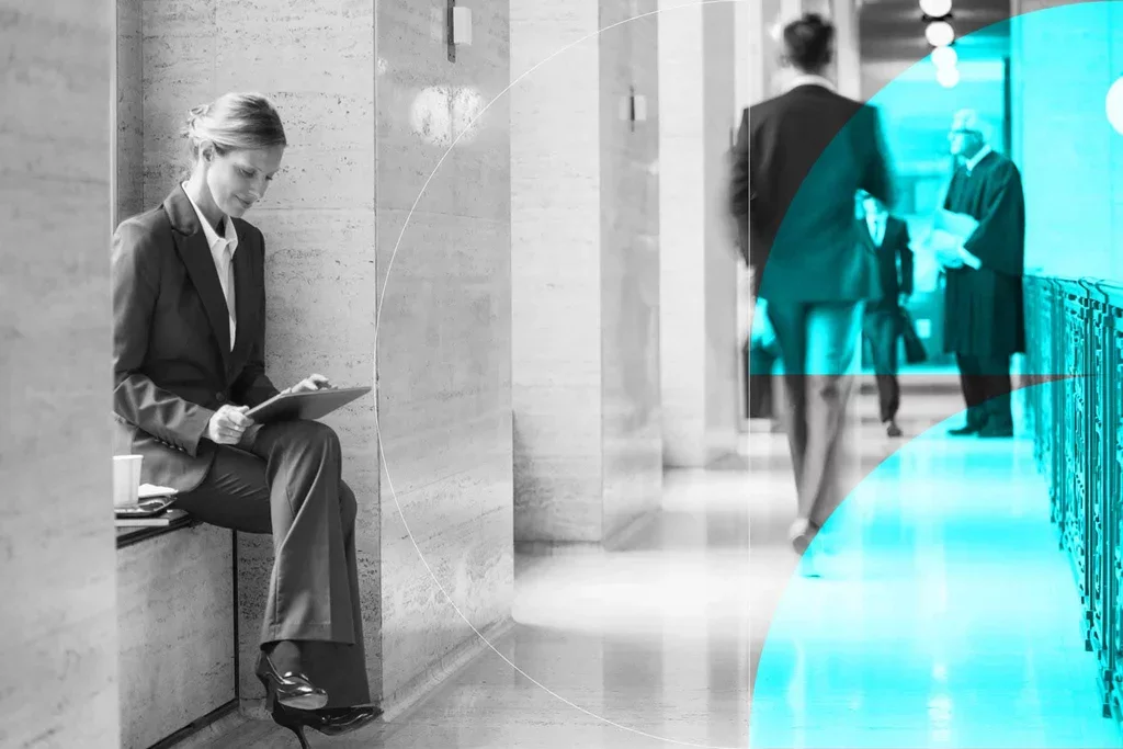 Business professional reviewing information on a tablet in a corporate office