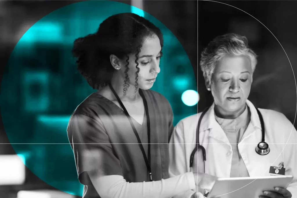 Healthcare professionals review information together on a tablet