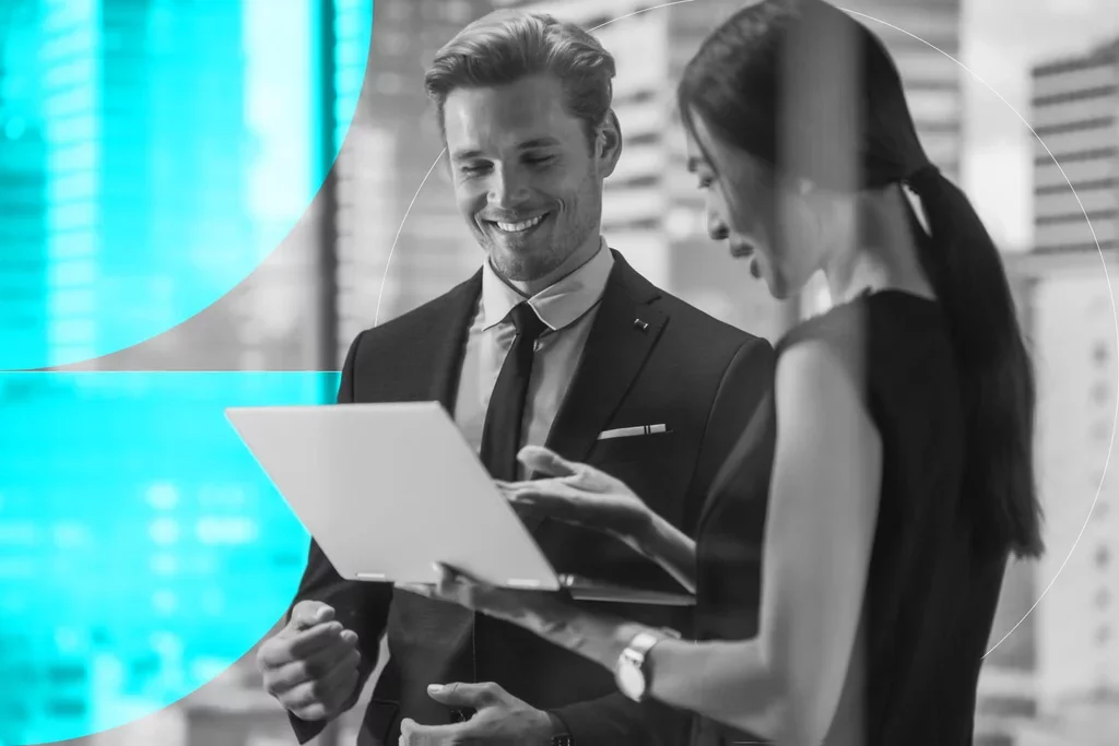 Two business professionals reviewing information together on a laptop