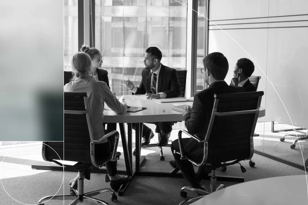 Business professionals discuss security strategy during a conference room meeting.