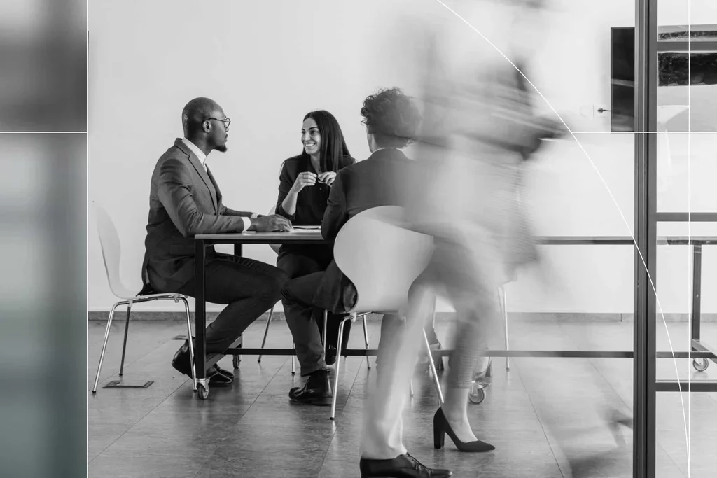 Business professionals collaborating around a table during an office meeting.