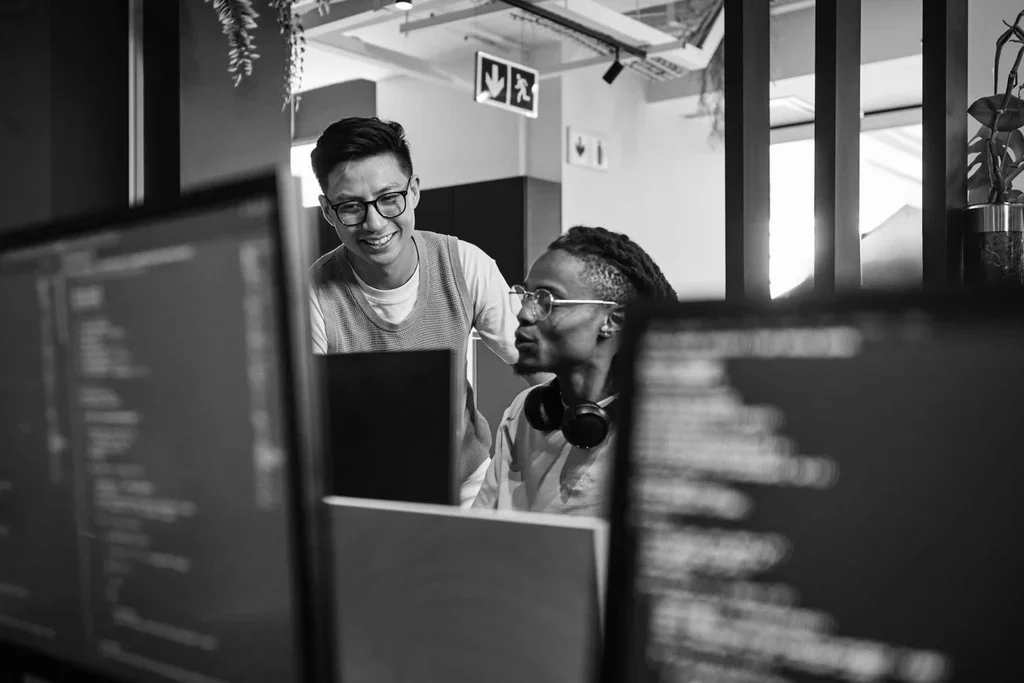 Cybersecurity team collaborating around a laptop in the workplace