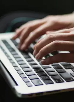 hands typing on keyboard
