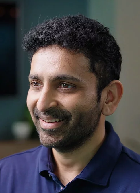 Portrait of smiling professional in casual office setting.