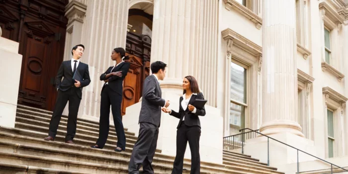 Business men and women standing on steps