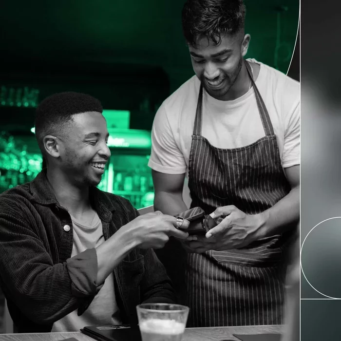 Customer completing a digital payment with a small business employee.
