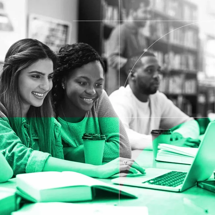 Students collaborate around a laptop while working together in a learning environment