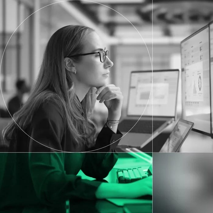 Security professional reviewing third-party risk data on multiple computer screens.
