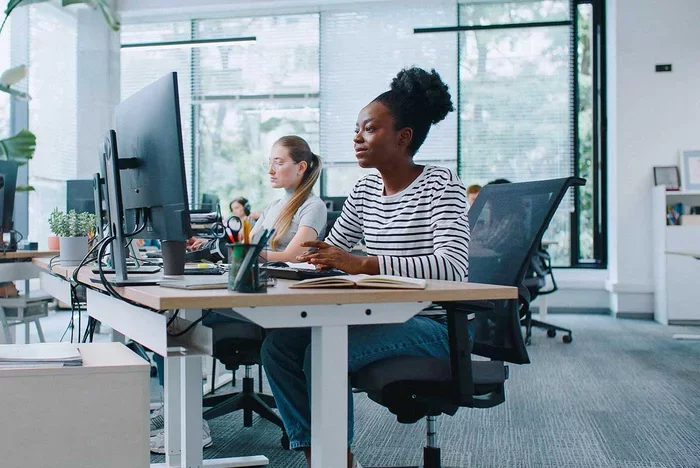 Security operations team monitoring systems and analyzing data in office workspace.