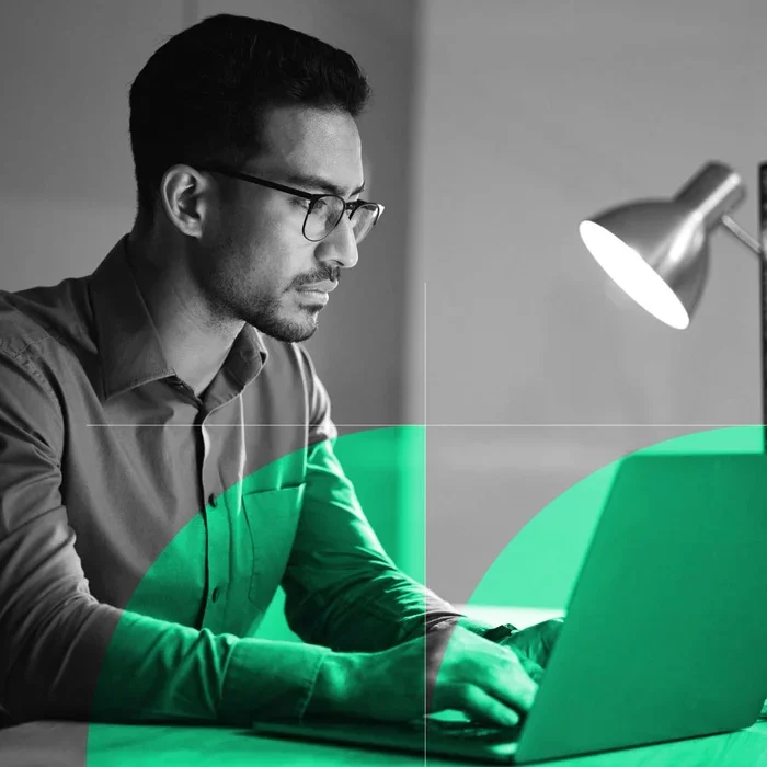 Business professional working on a laptop to help protect against email compromise