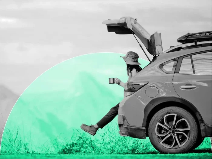Person holding a mug beside an SUV with its rear hatch open, framed by a green circular graphic.
