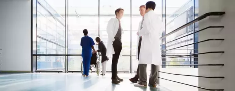 Three Male Physicians Discuss Healthcare Cybersecurity