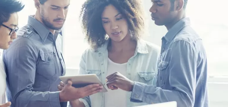 Three People Stare at iPad Protected by Secure Email Solution