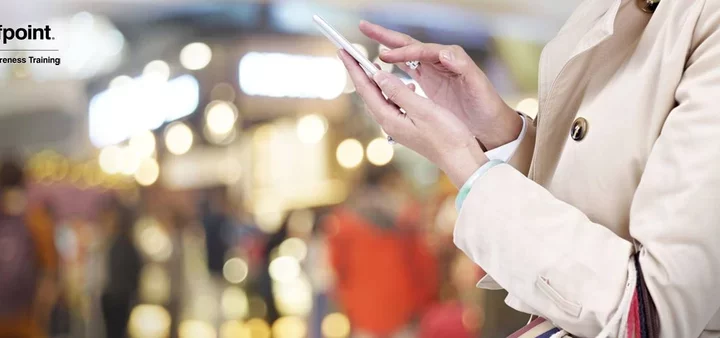 Businesswoman typing on her smartphone