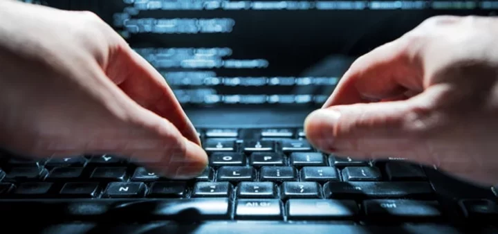Closeup of someone coding at a laptop keyboard