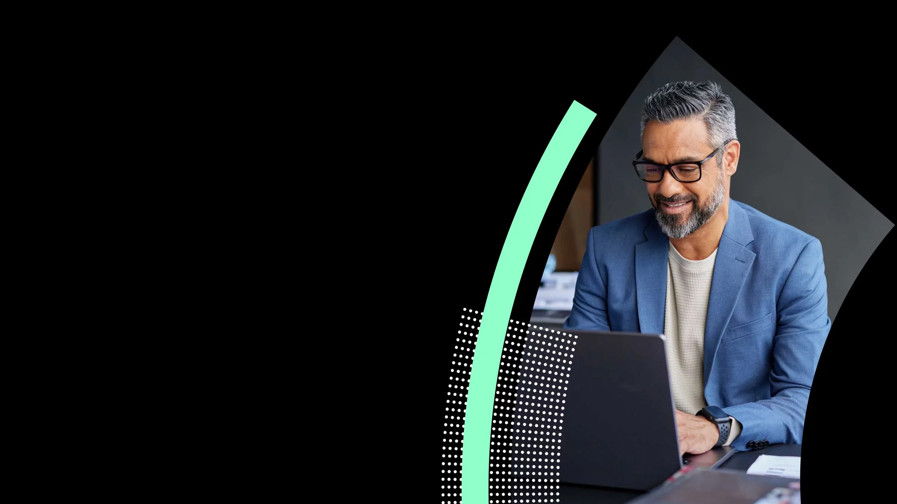 Professional working on laptop reviewing data in modern office.