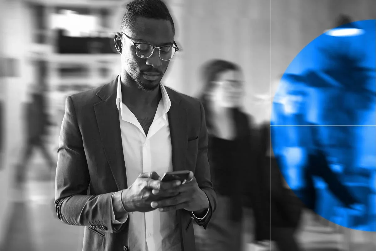 Professional using smartphone in office, representing digital transformation.