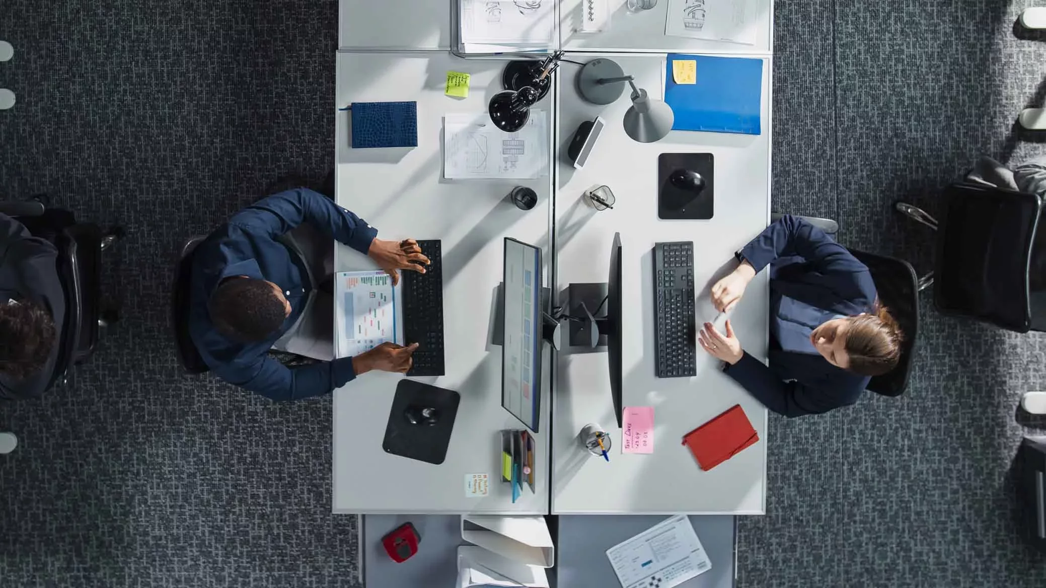 A security leader presenting analytics and risk metrics on a large digital display, highlighting visibility and control to eliminate shadow MCP risk across the enterprise.