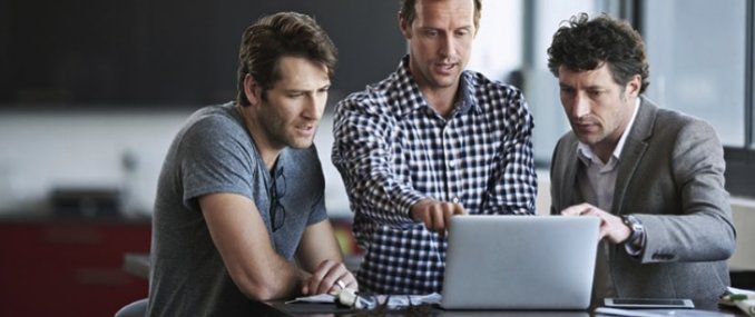 Male Employees Standing In Front of Laptop Protected by Cloud App Security