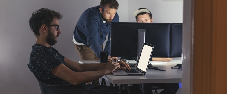  Employee Using Laptop Protected by a Digital Brand Protection Solution