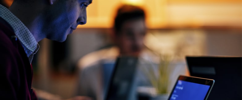 Man Using Social Media on Laptop Protected by Digital Protection